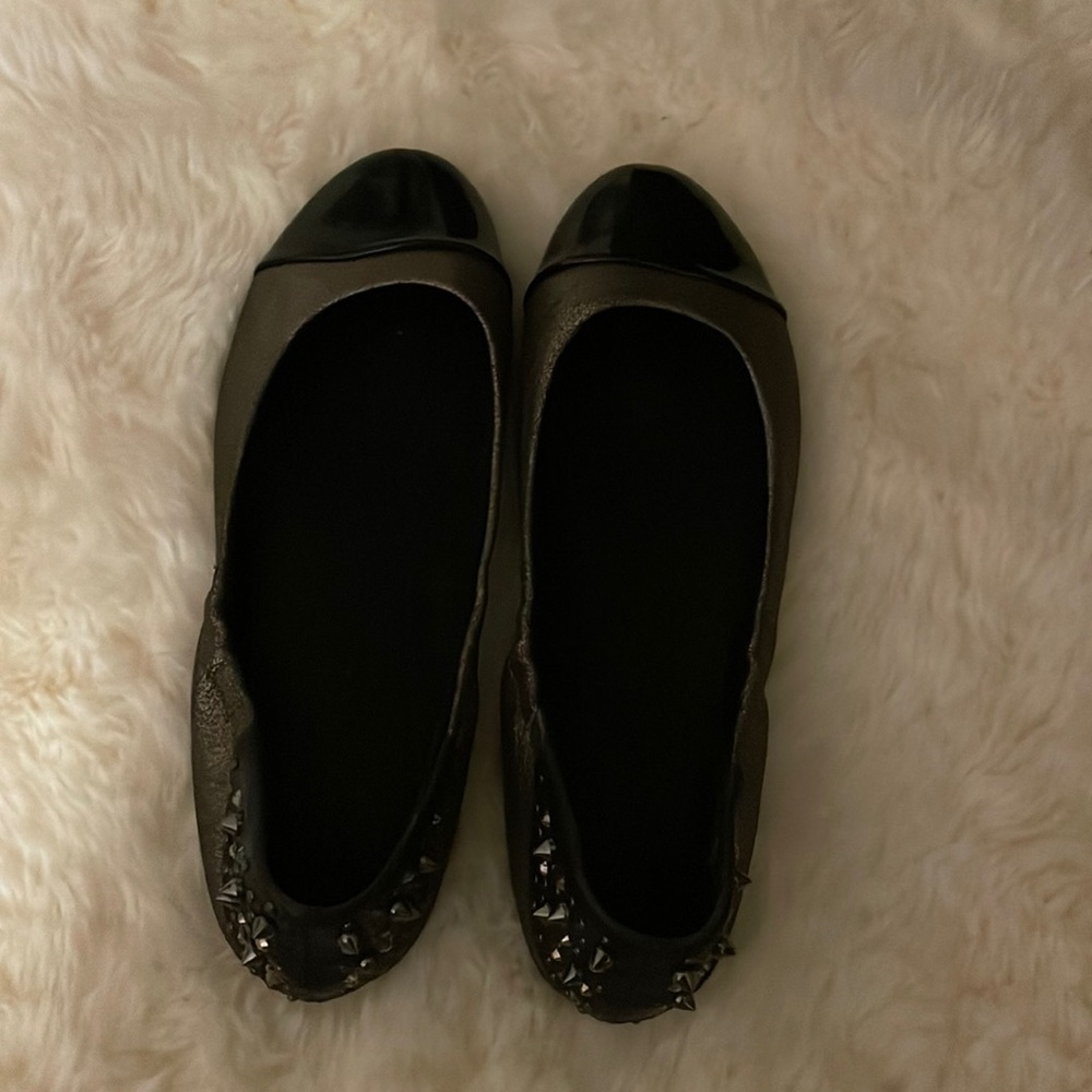 Report flat shoes with studs.